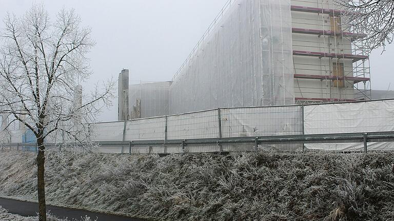 Auch im Nebel erkennbar: Die Arbeiten am Wiederaufbau der im Sommer abgebrannten Lagerhalle von Kräuter Mix laufen.